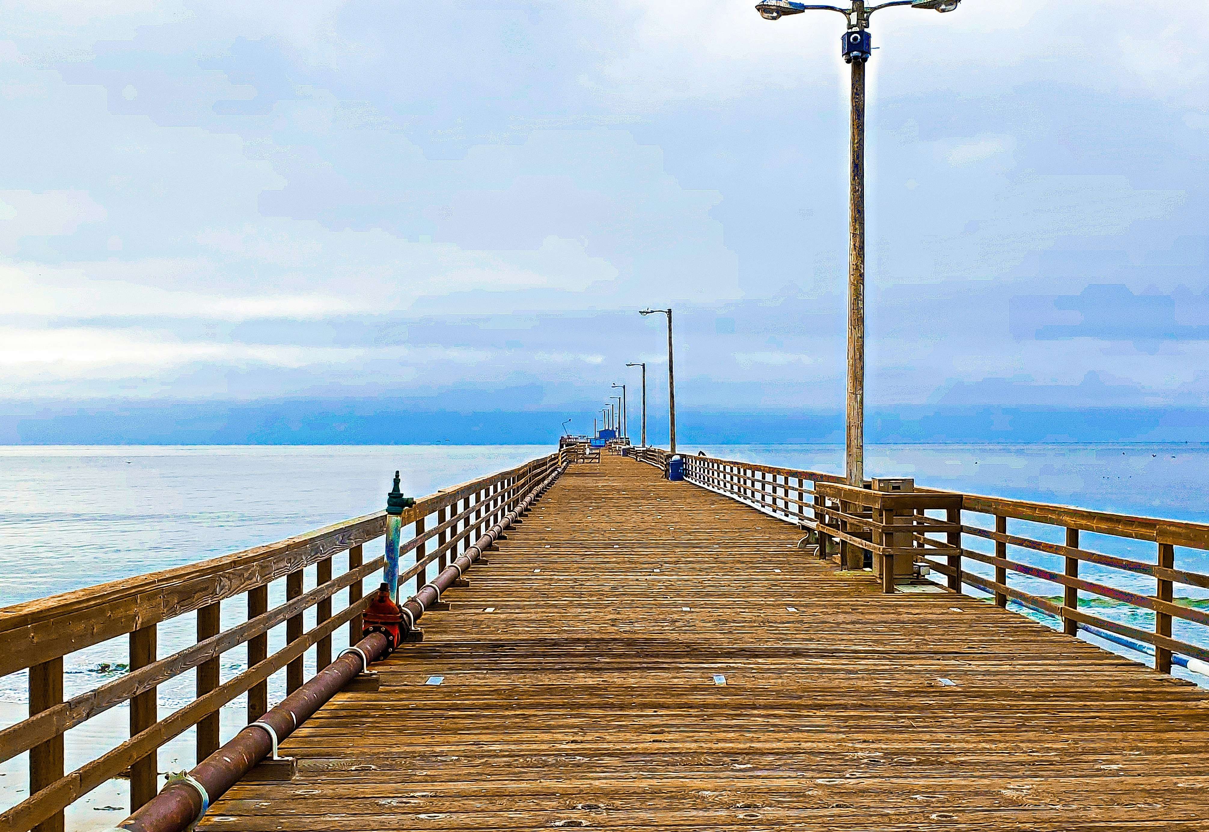 a wooden pier with a street light on top of it